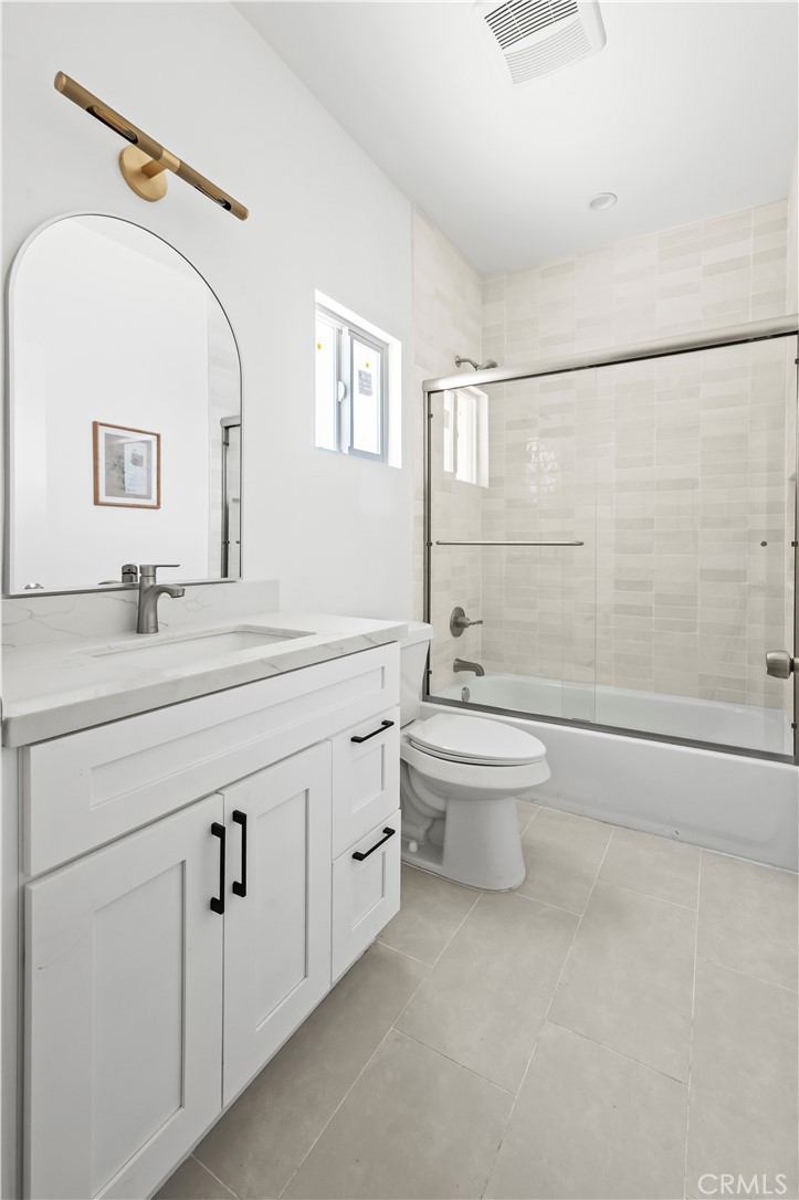 1056 Walter Avenue Tustin, CA 92780 - Photo 11 of 39 a bathroom with a double vanity sink toilet and shower