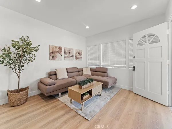 a living room with furniture and a potted plant