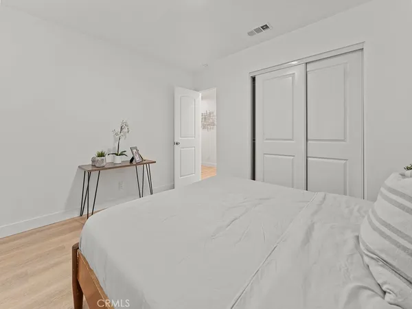 a bedroom with a bed and a mirror