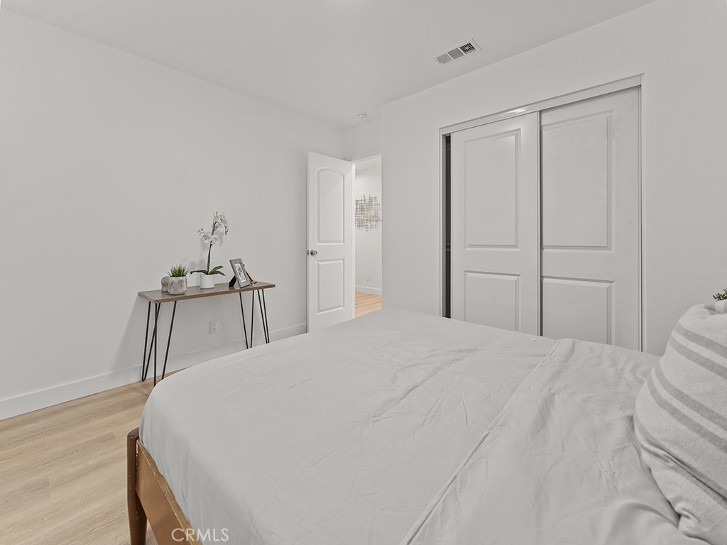 1056 Walter Avenue Tustin, CA 92780 - Photo 29 of 39 a bedroom with a bed and a mirror