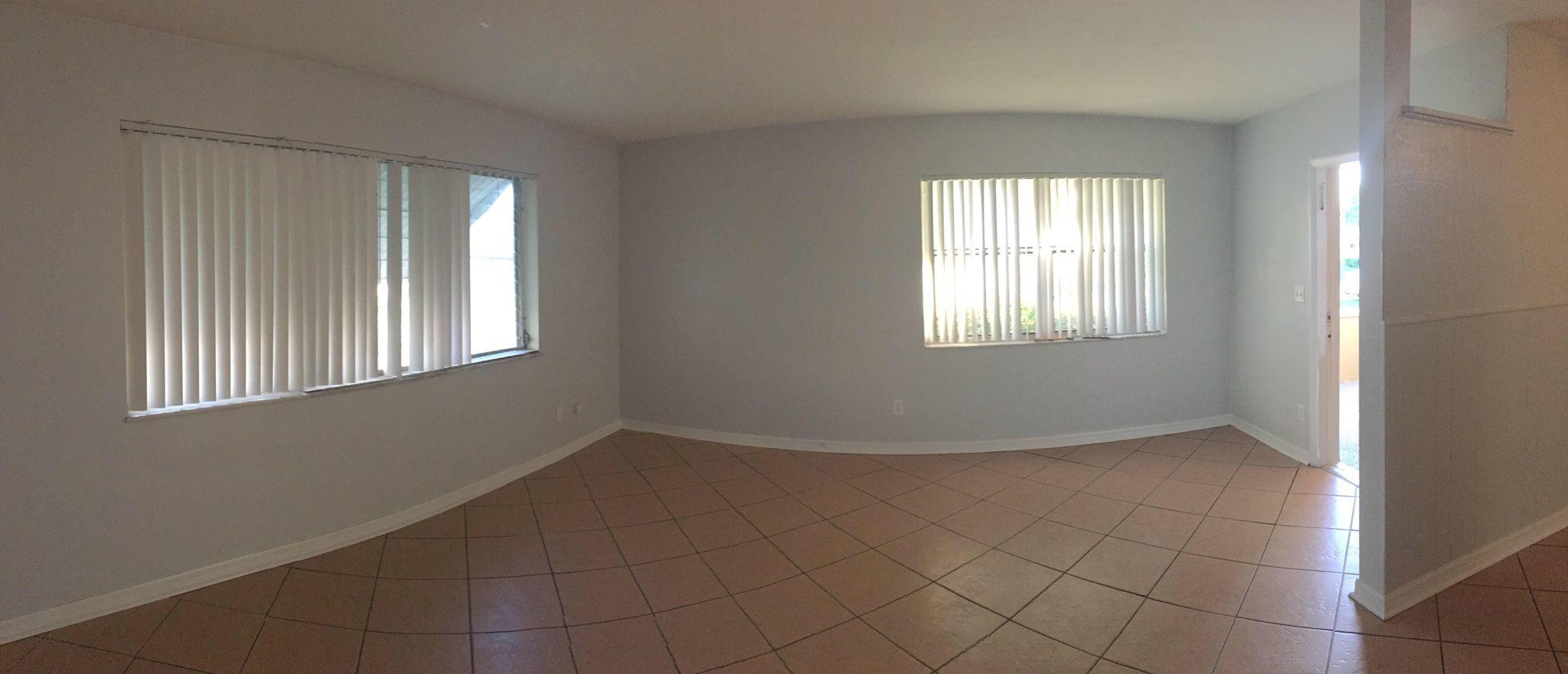 121 Southeast Bonita Court Port St. Lucie, FL 34983 - Photo 2 of 9 an empty room with windows