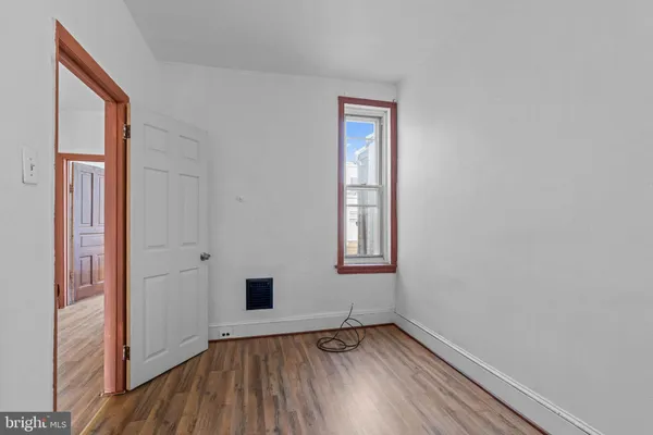 a view of an empty room and wooden floor