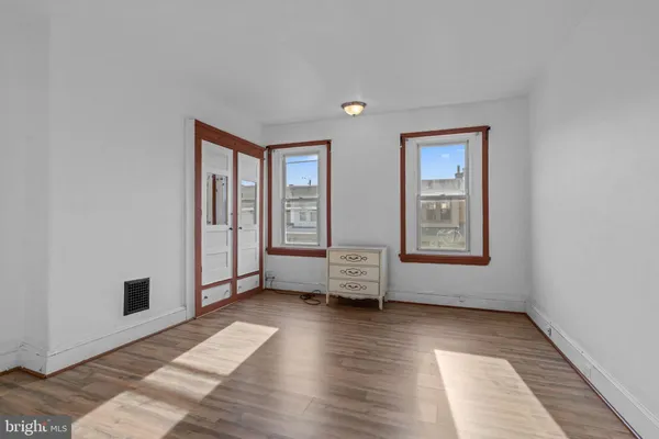 a bathroom with a toilet and a mirror