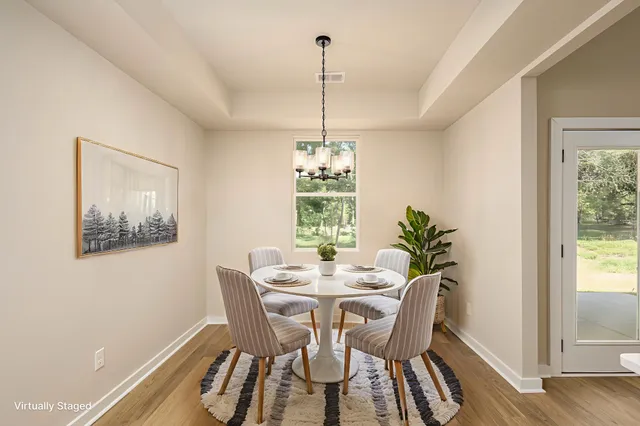 a dining room with furniture and window
