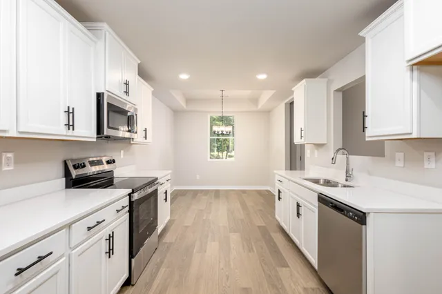 a kitchen with stainless steel appliances granite countertop a sink stove and oven