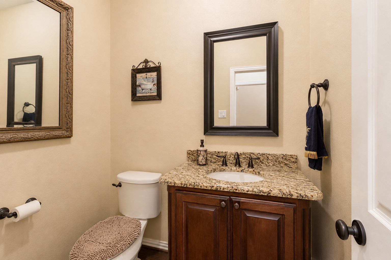 2326 Hamilton Pool Lane Friendswood, TX 77546 - Photo 8 of 49 a bathroom with a granite countertop toilet sink and mirror