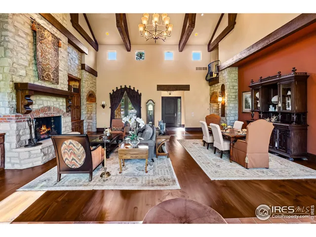 a living room with furniture a fireplace and open kitchen view