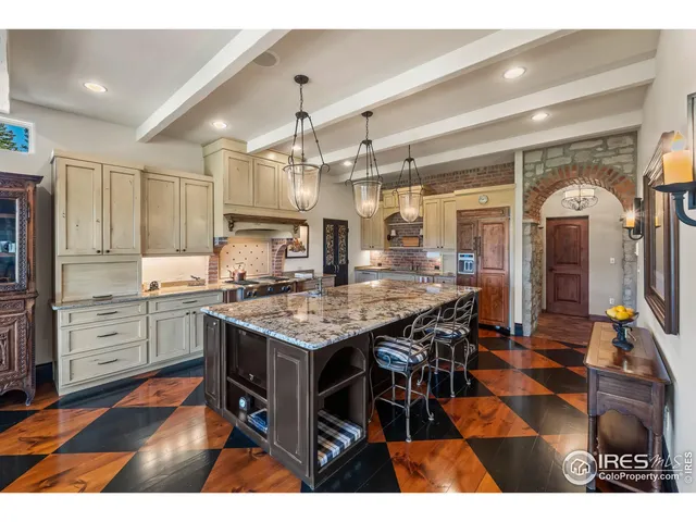 a kitchen with granite countertop a stove a counter top space and cabinets