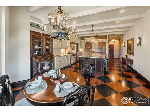 a dining room with furniture a chandelier and wooden floor