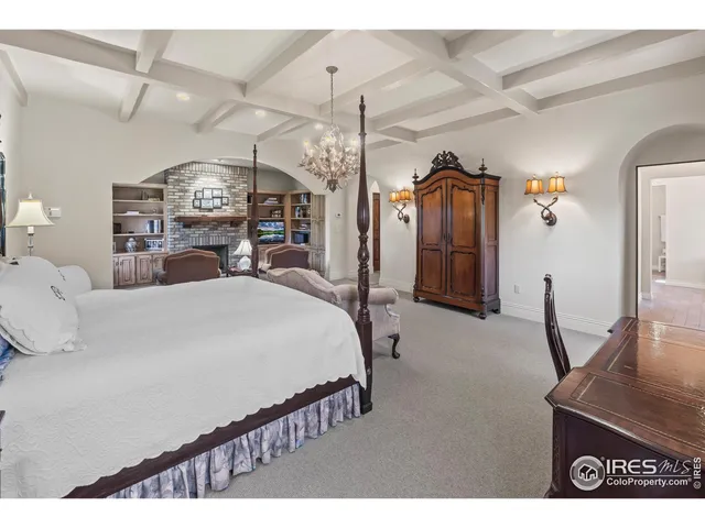 a bedroom with bed and wooden floor