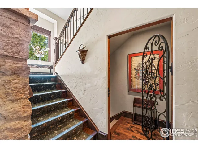 a living room with furniture and floor to ceiling windows
