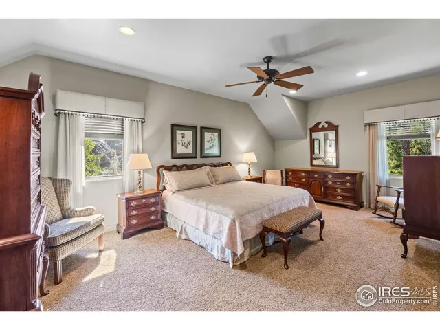 a bedroom with a bed window and a night stand