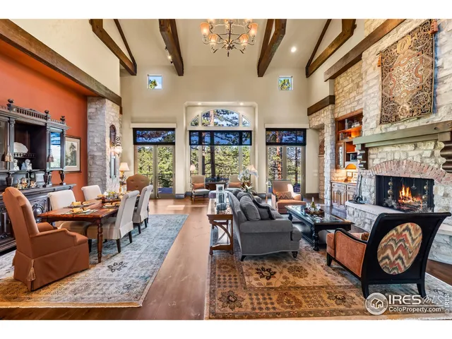 a living room with fireplace furniture and a large window