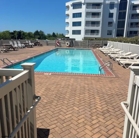 a bathroom with a granite countertop shower and a sink