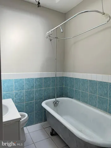 a bathroom with a white bath tub and a sink