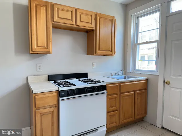 a utility room with granite countertop cabinets washer and dryer