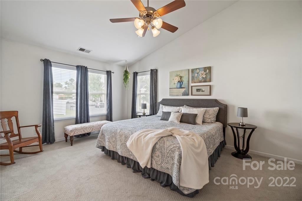 7383 Laurel Valley Road Charlotte, NC 28273 - Photo 24 of 37 a bedroom with a bed a chair and a large window