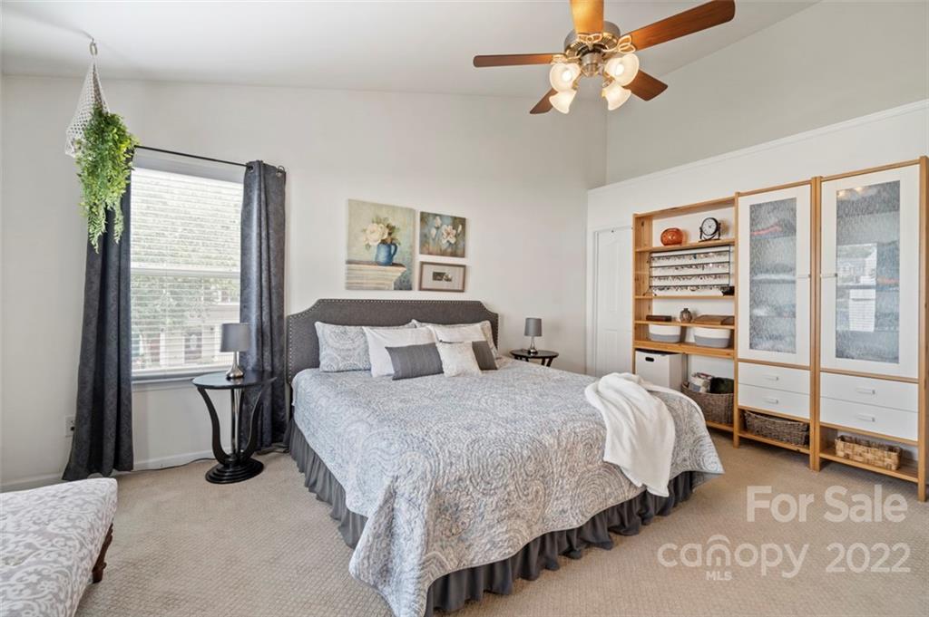 7383 Laurel Valley Road Charlotte, NC 28273 - Photo 26 of 37 a bedroom with a bed and a chandelier