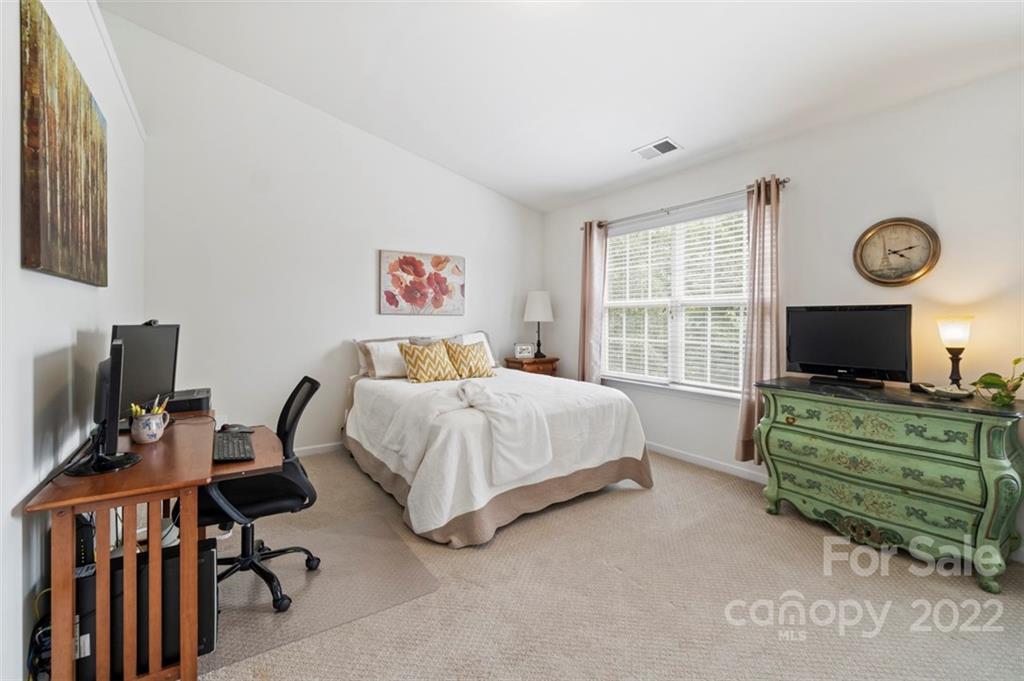 7383 Laurel Valley Road Charlotte, NC 28273 - Photo 28 of 37 a bedroom with a bed and a flat screen tv