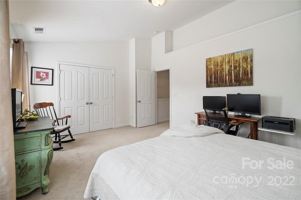 7383 Laurel Valley Road Charlotte, NC 28273 - Photo 30 of 37 a bedroom with a bed a television and a desk