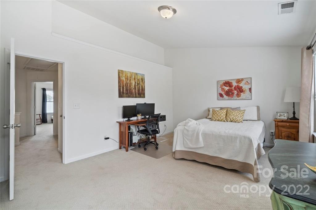 7383 Laurel Valley Road Charlotte, NC 28273 - Photo 31 of 37 a spacious bedroom with a bed and a couch