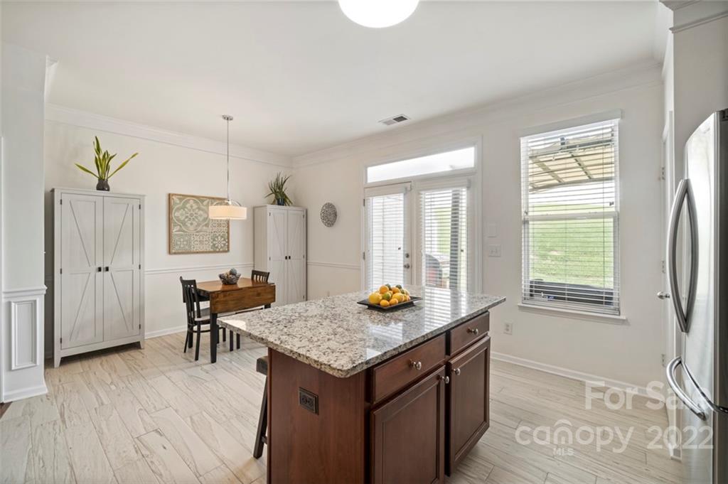 7383 Laurel Valley Road Charlotte, NC 28273 - Photo 6 of 37 a kitchen with granite countertop kitchen island wooden floor center island and stainless steel appliances