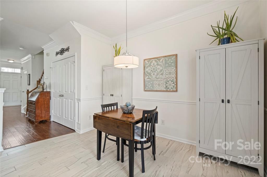 7383 Laurel Valley Road Charlotte, NC 28273 - Photo 8 of 37 a view of a dining room with furniture and wooden floor