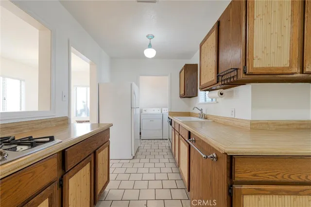 a kitchen with stainless steel appliances a sink stove and cabinets