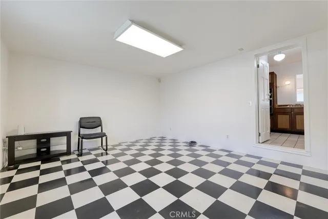 a living room with a black white checkered floor