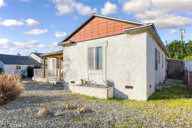 a backyard of a house with potted plants