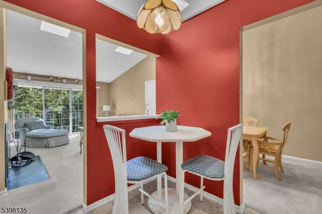 a view of a dining room with furniture wooden floor and chandelier