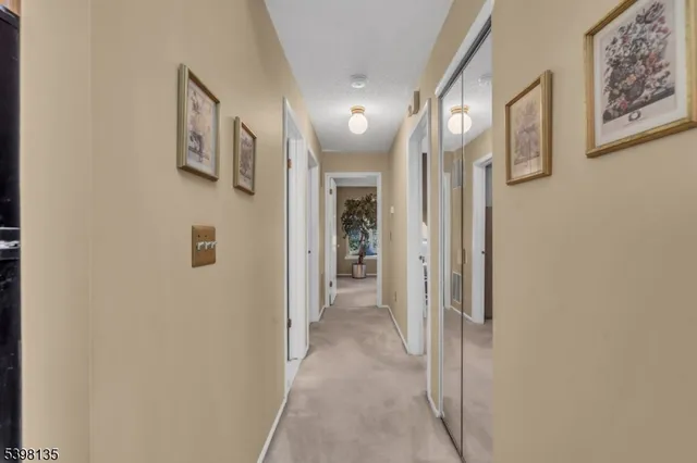 a view of a hallway with wooden shelves