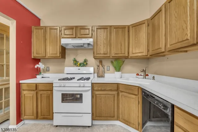 a kitchen with a sink stove and cabinets