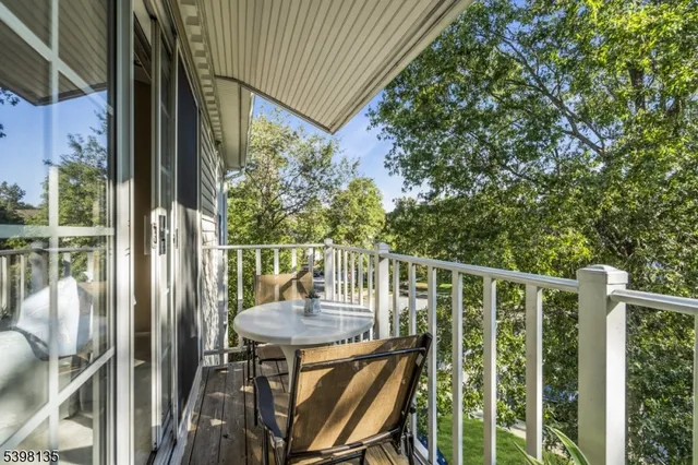 a view of a balcony with chair and wooden floor