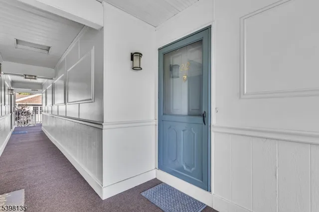 a view of a hallway with stainless steel appliances
