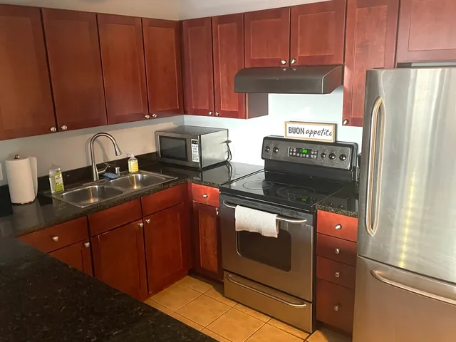 a kitchen with a stove and a refrigerator