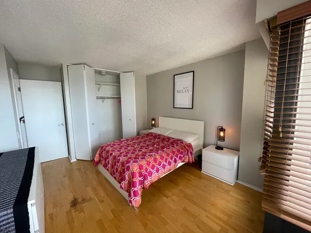 a bedroom with a bed and a mirror