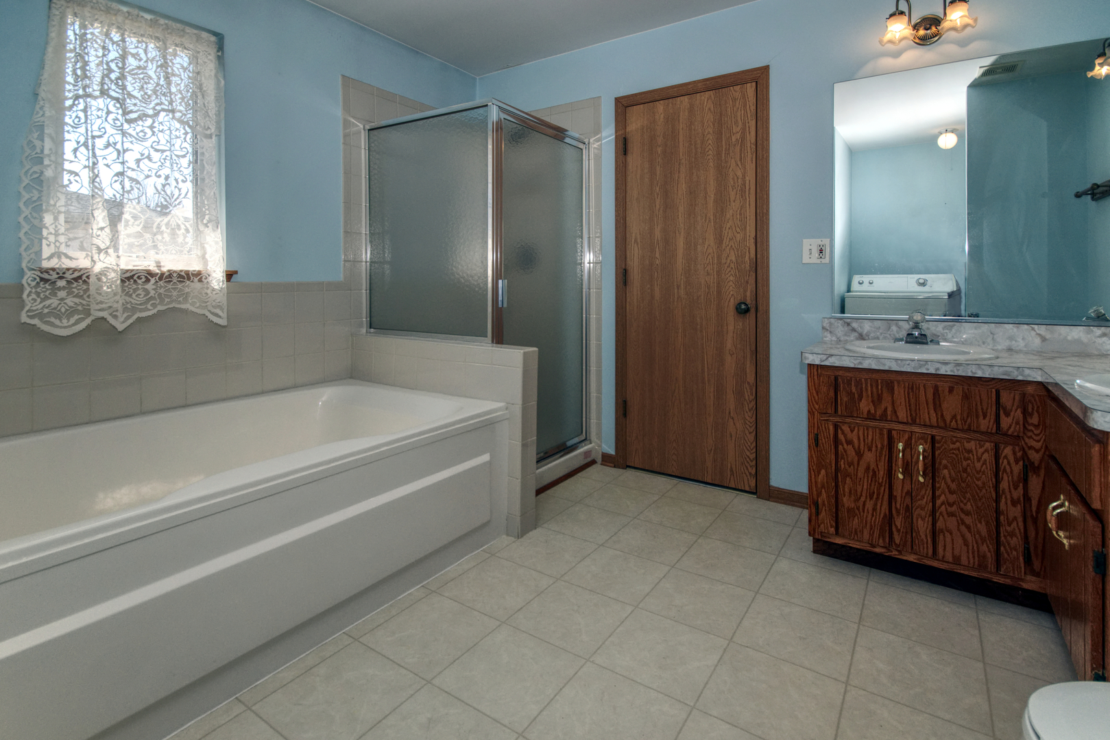 2103 Olde Mill Road Plainfield, IL 60586 - Photo 15 of 21 a spacious bathroom with a tub sink and mirror