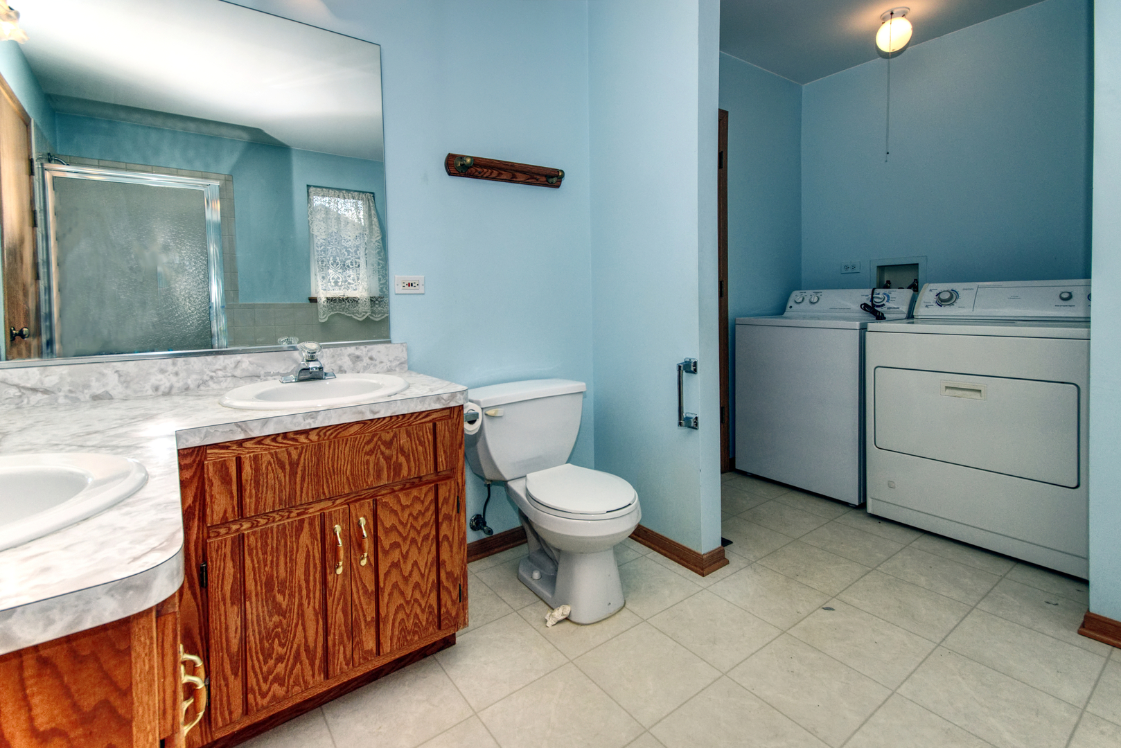 2103 Olde Mill Road Plainfield, IL 60586 - Photo 16 of 21 a bathroom with a toilet sink vanity and mirror