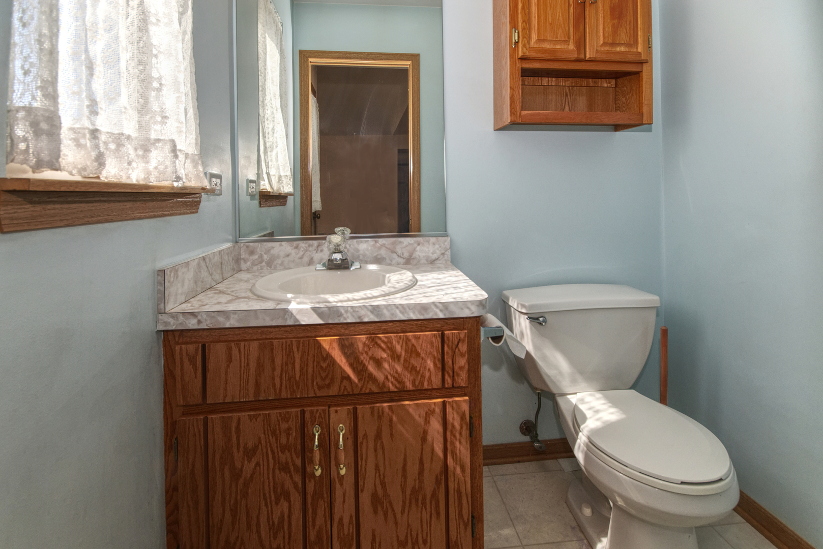 2103 Olde Mill Road Plainfield, IL 60586 - Photo 17 of 21 a bathroom with a toilet sink and mirror