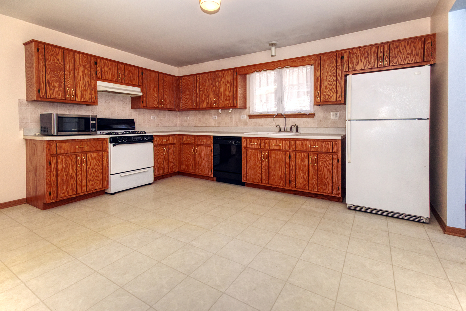 2103 Olde Mill Road Plainfield, IL 60586 - Photo 6 of 21 a kitchen with stainless steel appliances granite countertop a refrigerator sink and cabinets