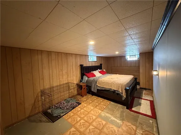 a bed sitting in a bedroom next to a window