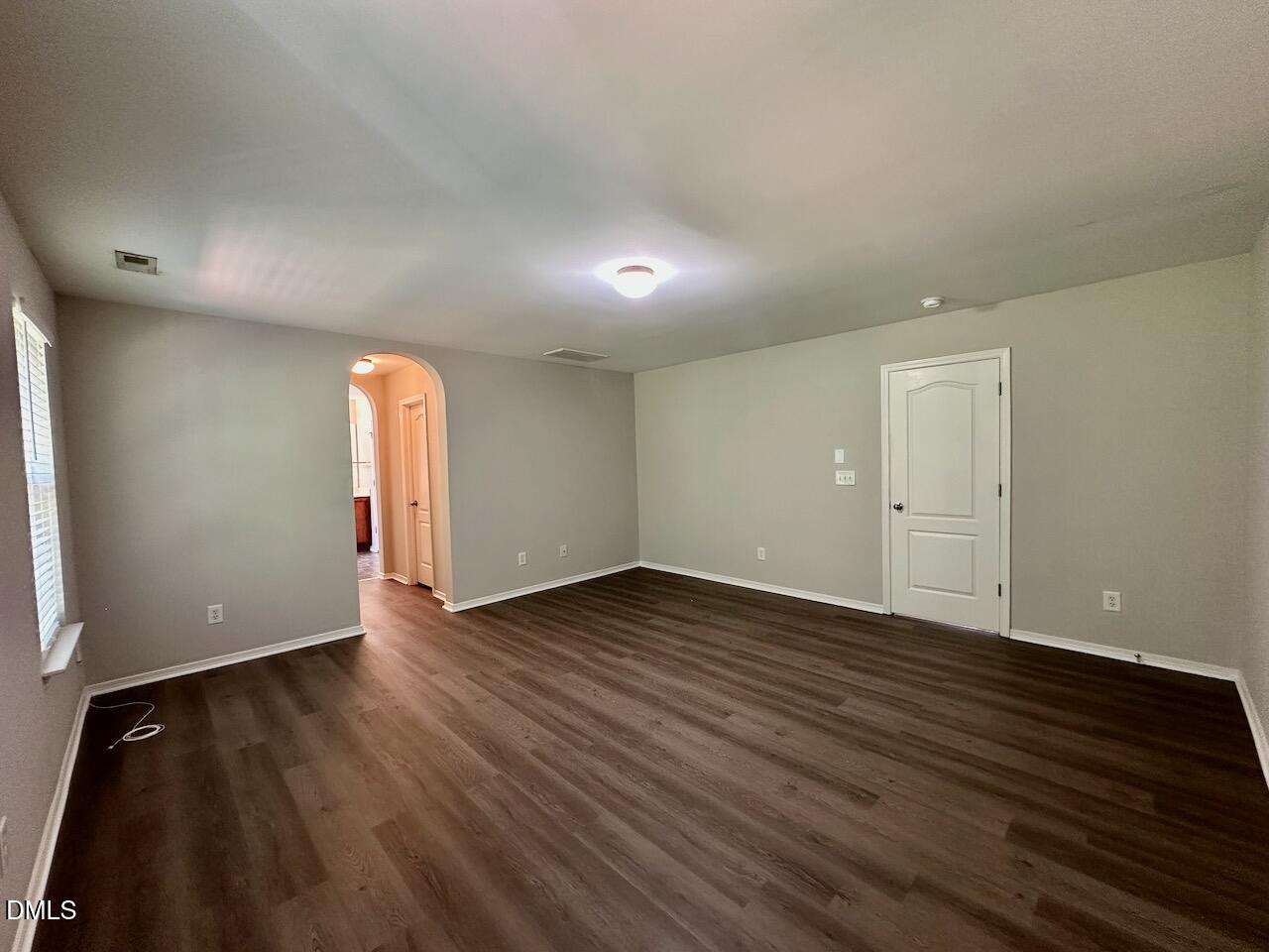 8208 Stone Cellar Drive Raleigh, NC 27613 - Photo 20 of 34 an empty room with wooden floor and windows