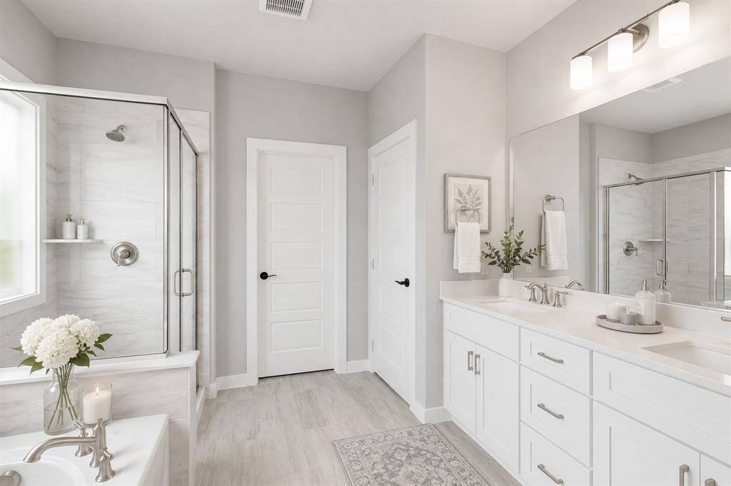 3311 Willena Road Melissa, TX 75454 - Photo 12 of 40 Spacious bathroom featuring a dual vanity with white cabinetry and countertops, a large framed mirror, a walk-in shower with clear glass enclosure and tiled walls, and wood-finish flooring