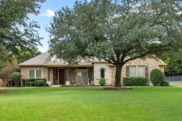 a front view of a house with a garden and porch