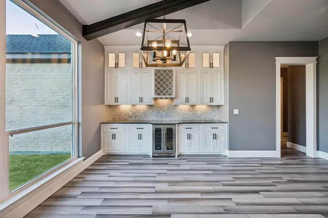 a view of a room with wooden floor staircase and a kitchen