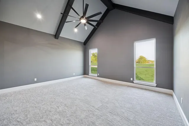 a large white kitchen with a white countertops a dining table and chairs