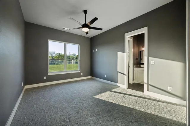 a bathroom with a granite countertop sink vanity and mirror