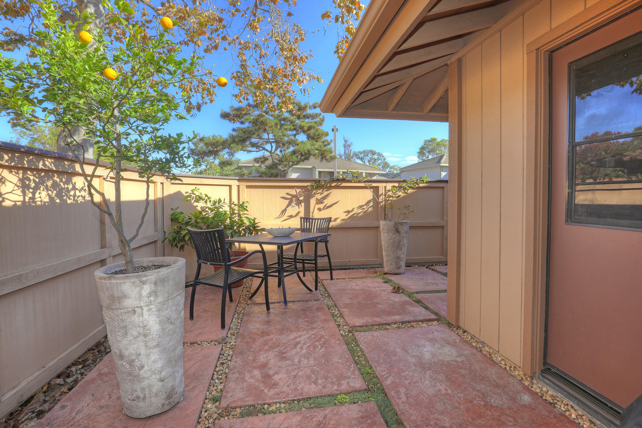 5290 Overpass Road, Unit 4 Goleta, CA 93111 - Photo 13 of 21 a view of a patio with table and chairs under an umbrella