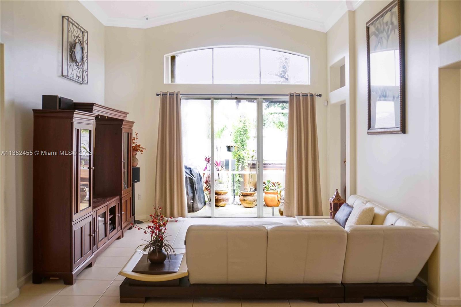 Miramar Miramar, FL 33029 - Photo 15 of 18 a living room with furniture a large window and a flat screen tv
